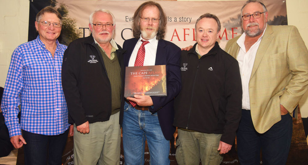 Table Mountain National Park (TMNP) Fire Manager Philip Prins and CPFPA General Manager Pierre Gallagher (second from left and right) join the Cape Aflame Project's Les Maartens (Procurement), Mike Golby (Author) and Kevin Gleeson (Project Lead) at the handover function. Photograph: Kim Bouchier The Cape Aflame